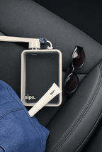 A clear rectangular water flask made by Sips with a light grey bumper and cap, resting on a black car seat alongside black sunglasses, a blue denim jacket, and a white tube labeled REFY. 