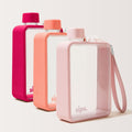 Three clear reusable Sips water bottles with textured pink protective bumpers, arranged in a row on a plain background. The bottles are in three colorways: sorbet (bright pink), coral, and candy (light pink). They are the perfect trio for coordinating water bottles.